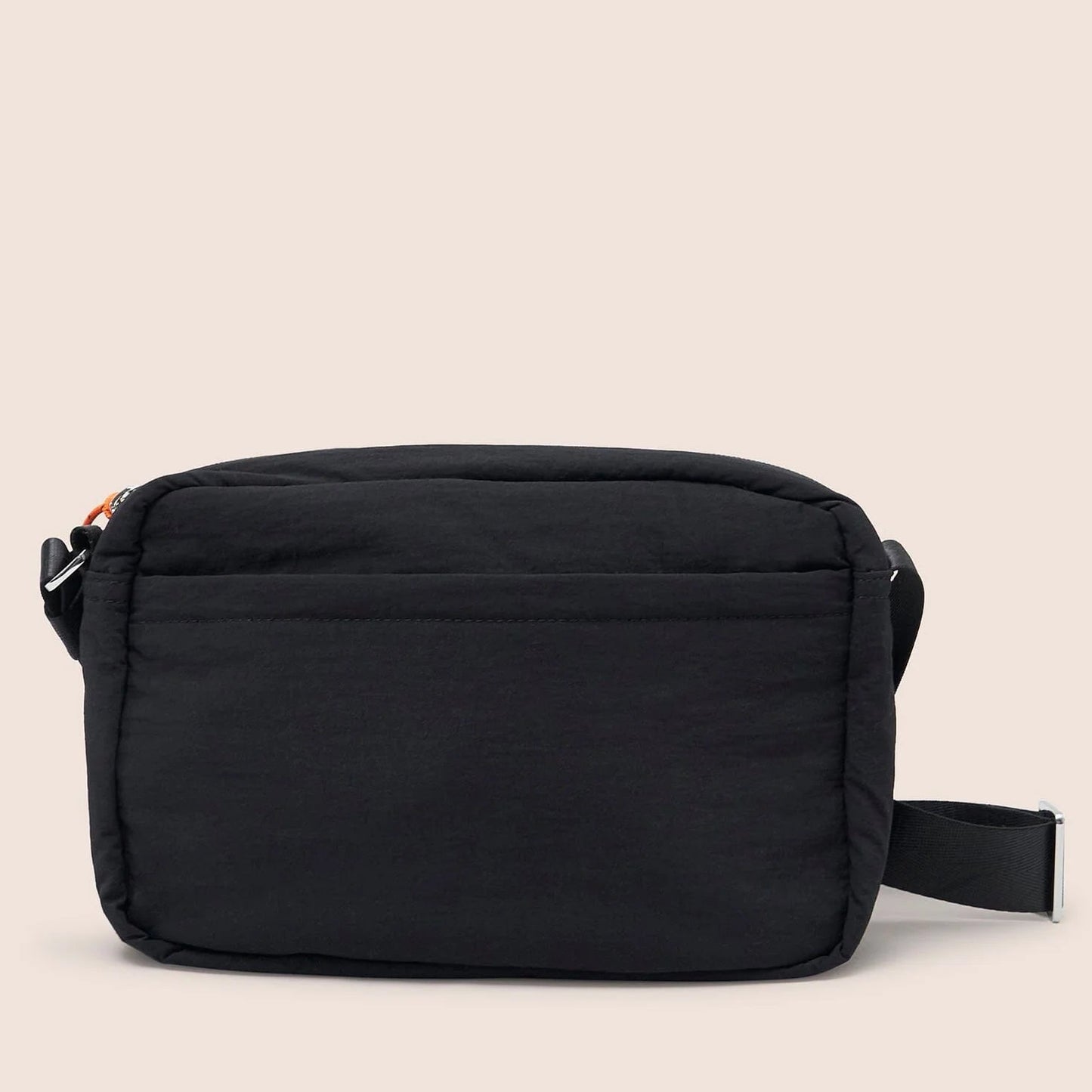 Black crossbody bag on a beige background
