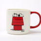 white mug with red handle. illustration on the front of a red house with soppy laying on top