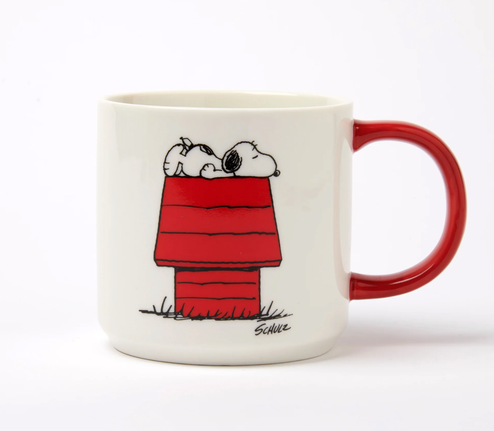 white mug with red handle. illustration on the front of a red house with soppy laying on top