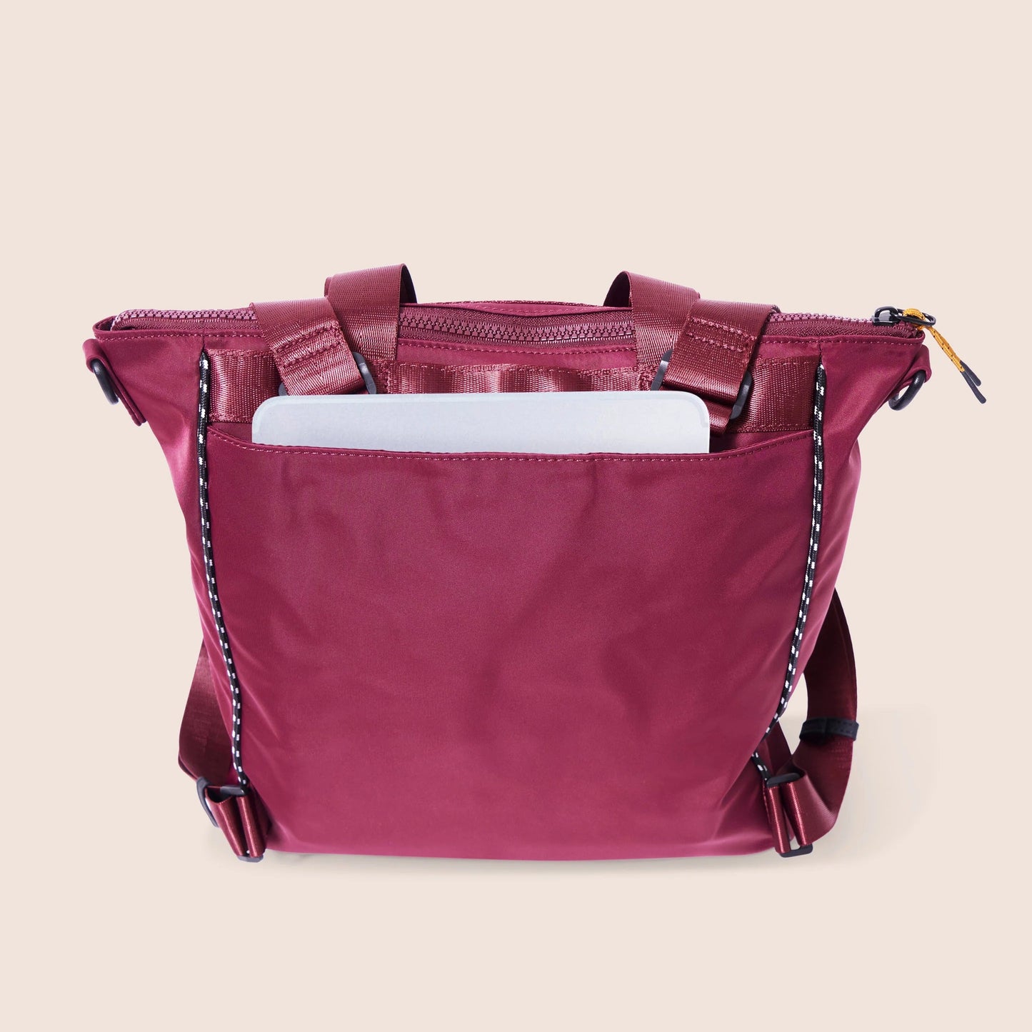 Pink handbag with a chain detail on a beige background