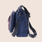 Blue backpack with a strap on a beige background
