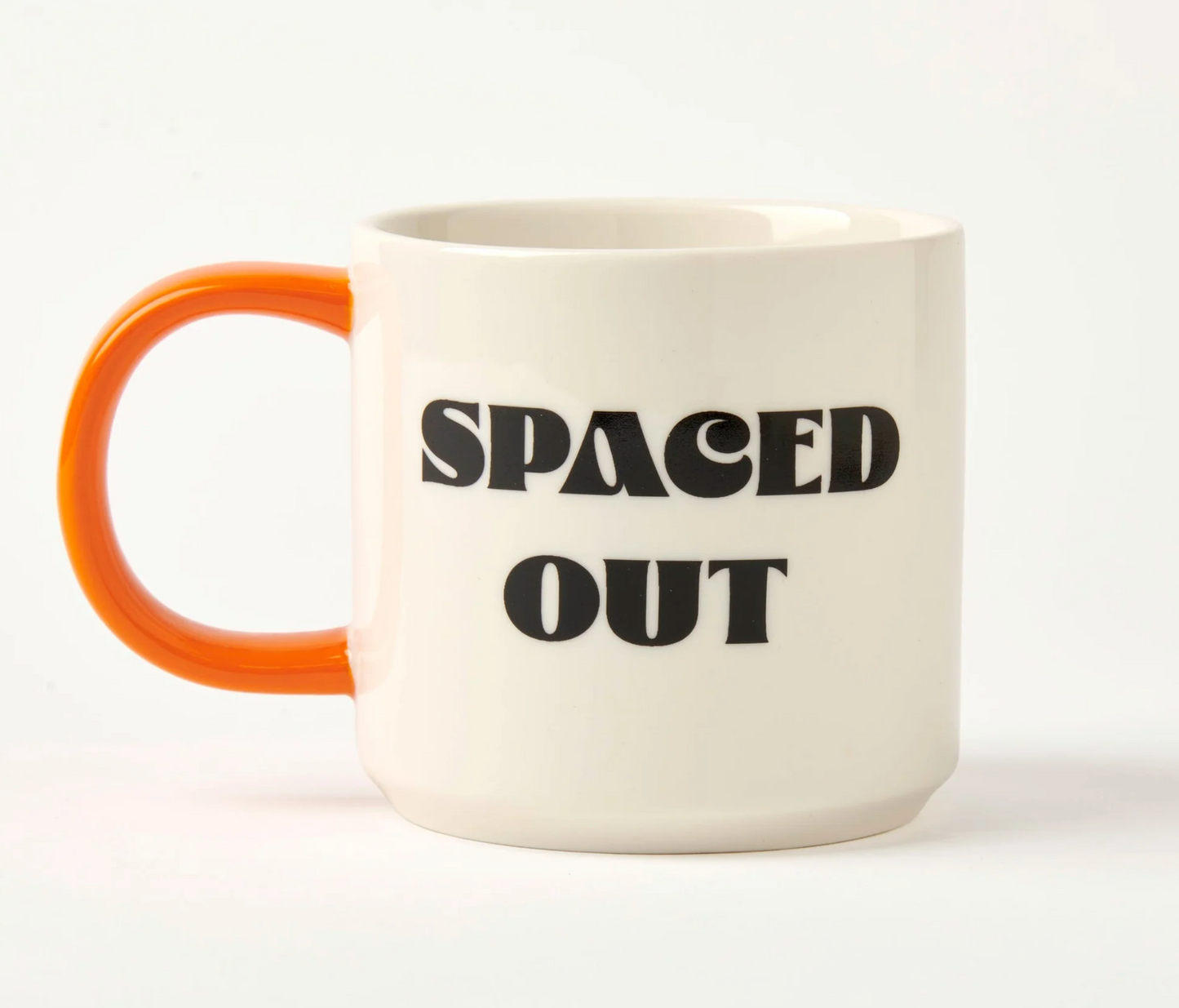 white mug with orange handle and black 'SPACED OUT' text on a white background