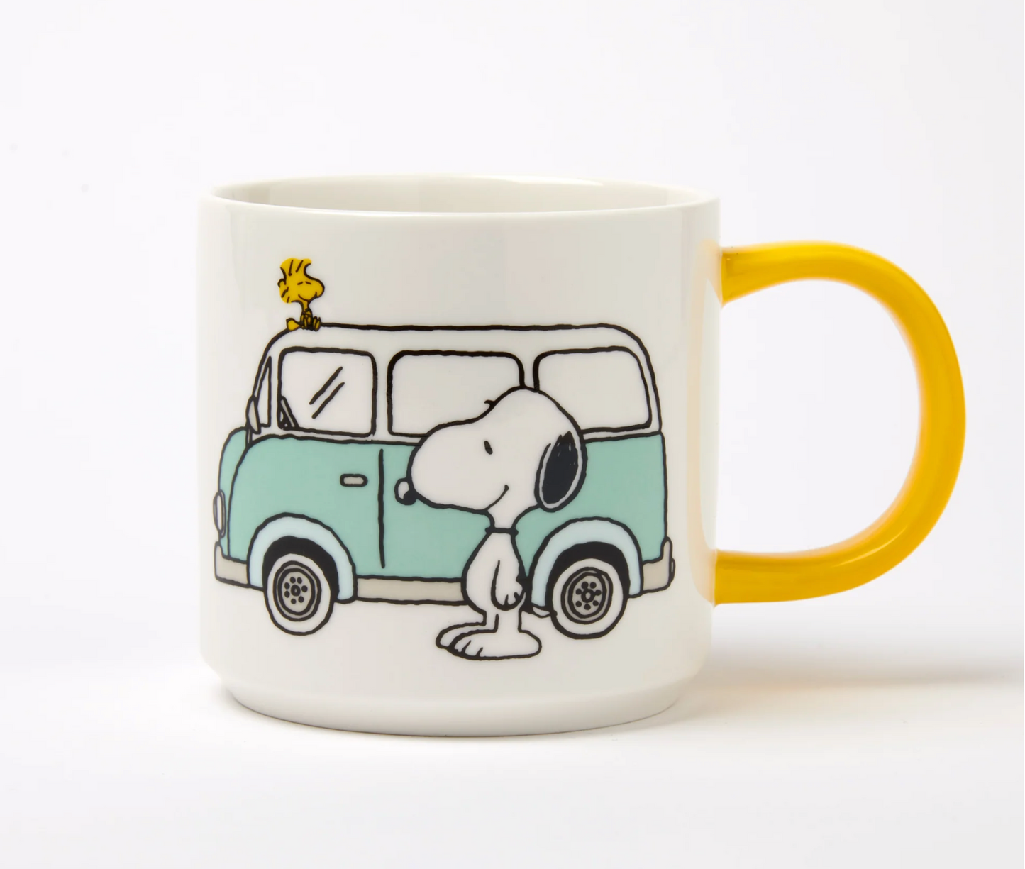 white mug with yellow handle. printed image of snoopy and woodstock with a blue camper van 