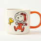 white mug with orange handle Snoopy in an astronaut suit and Woodstock on a white background