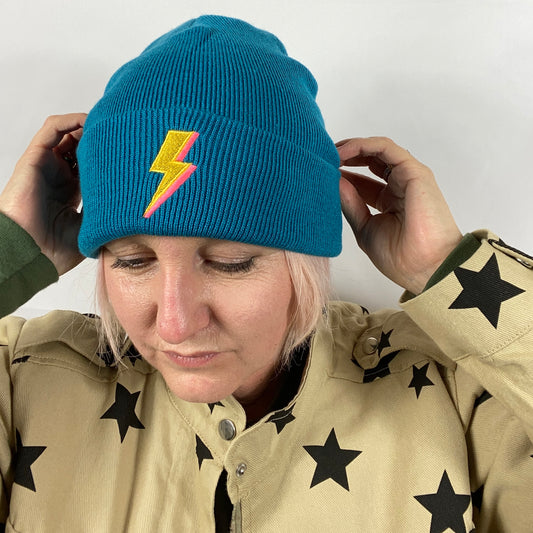 Embroidered to match our ever popular lighting bolt design.  Available in Teal or black  Beanies are made from 100% soft-touch acrylic in a double layer knit. One size fits all. Glitter & Mud