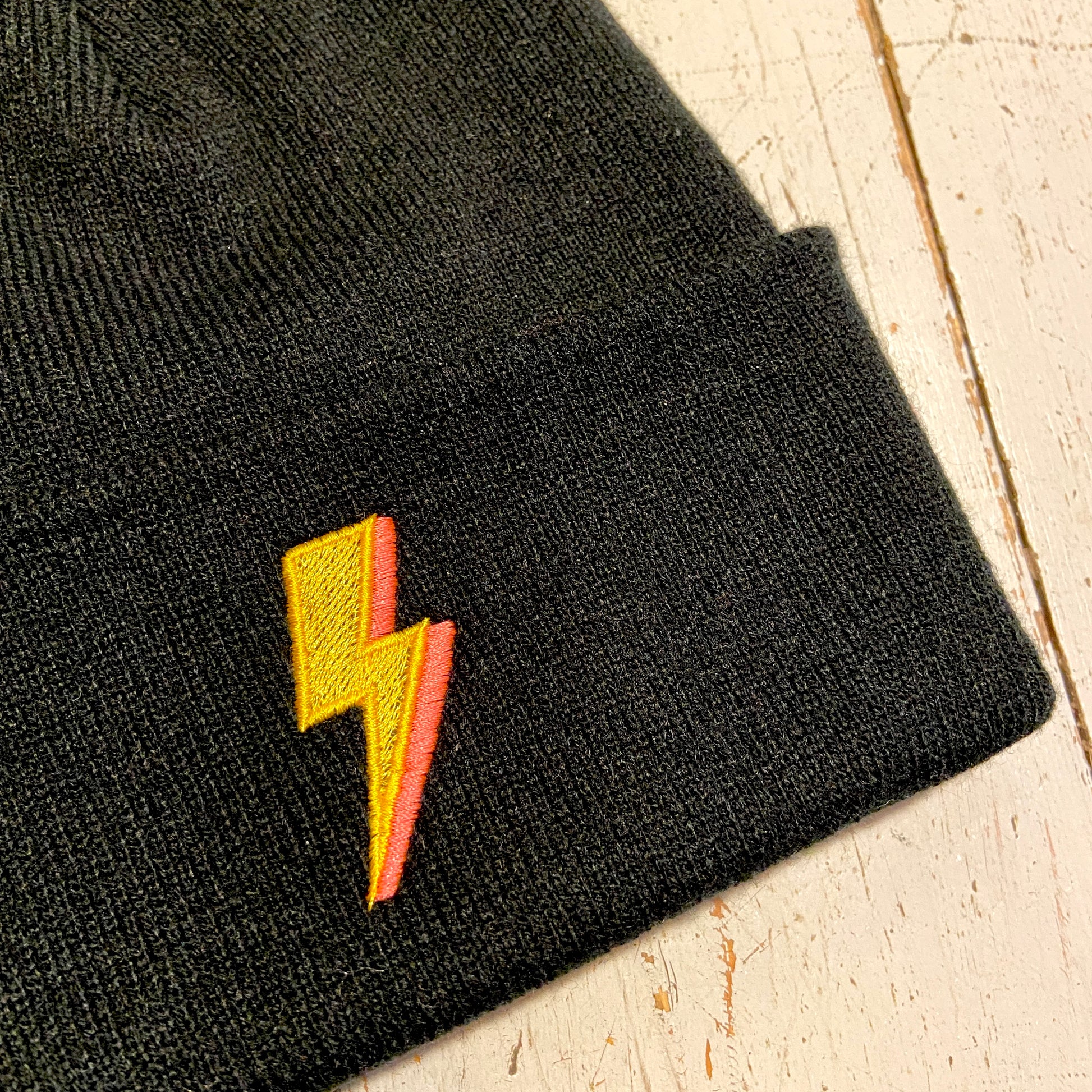 Embroidered to match our ever popular lighting bolt design.  Available in Teal or black  Beanies are made from 100% soft-touch acrylic in a double layer knit. One size fits all. Glitter & Mud