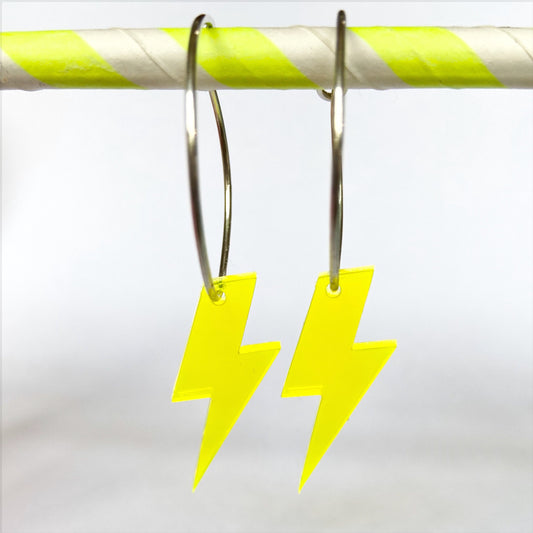 A little  pop, with a flash of a neon lightning bolt earring is fun statement to brighten the blackest of dresses.  Made by us from silver wire & fashioned into hoops with  a neon lightning bolt pop. Glitter and Mud