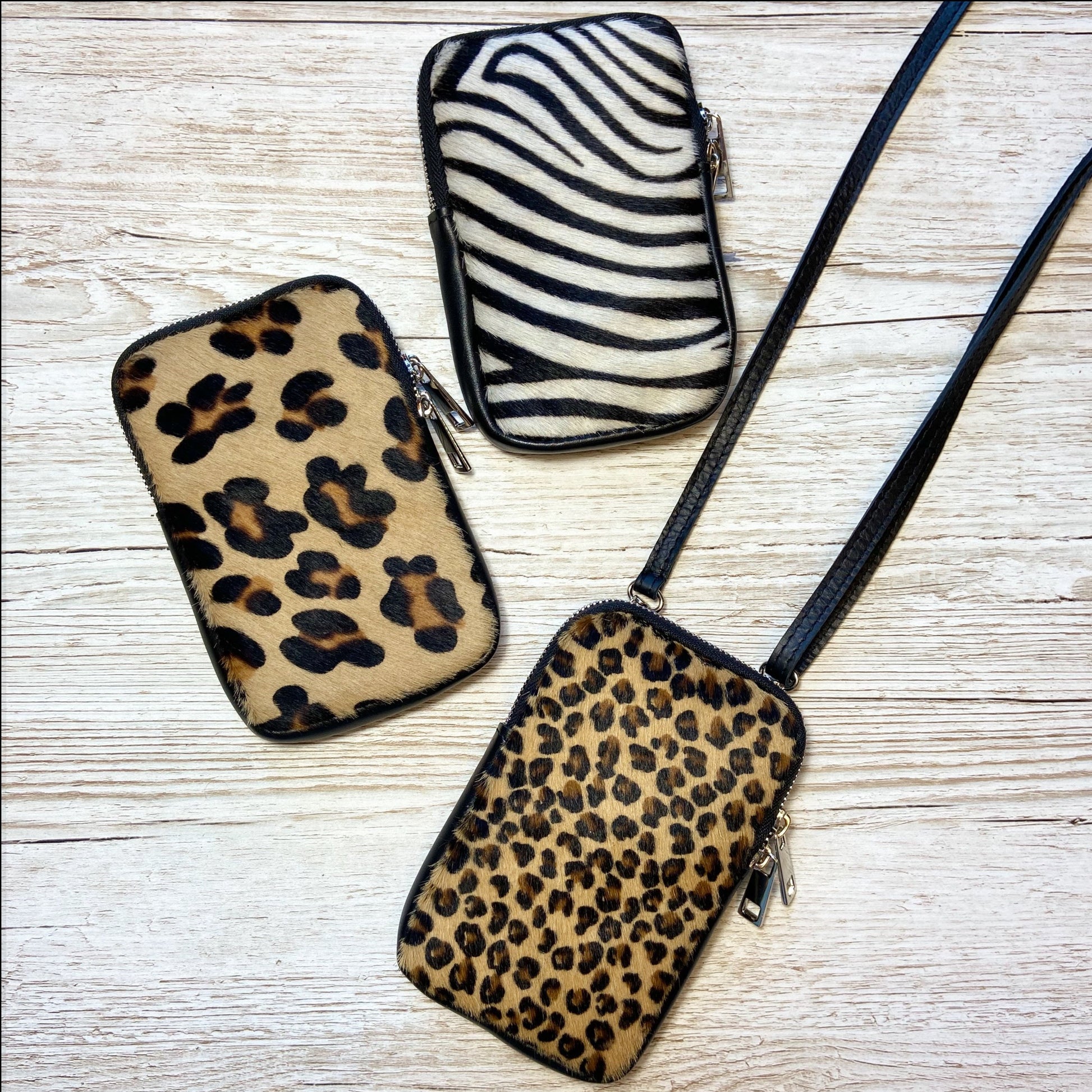 Beautiful cow hair leopard or zebra print leather phone bags, superb quality with silver hardware & double zips. A great size to hold your phone or purse or a couple of essentials without the bulk of a huge bag.